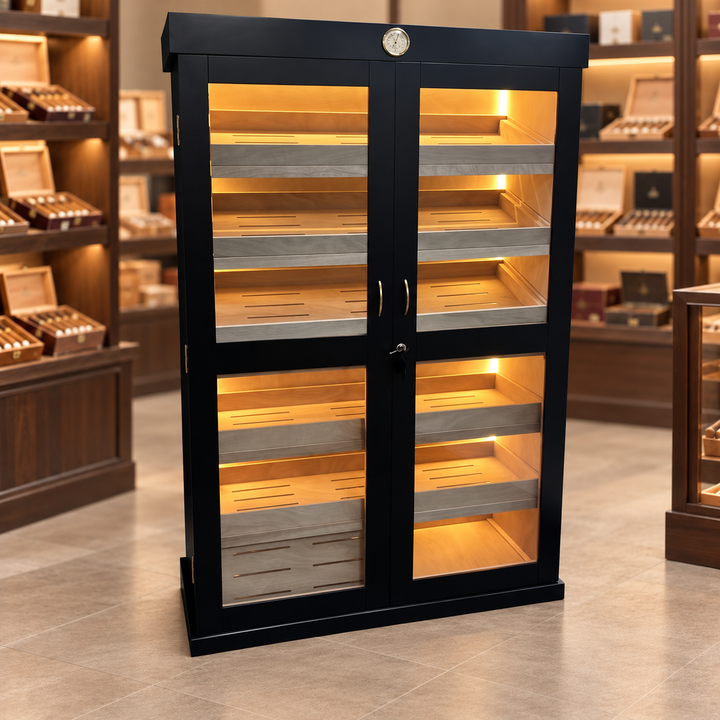Black double-door humidor with illuminated cedar shelves in a cigar shop